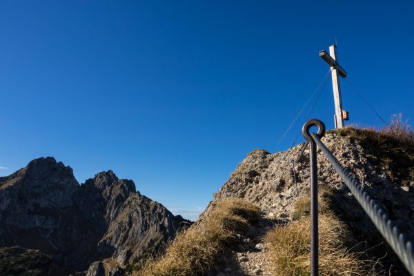 Mountain summit with summit cross in the Alps - Ammergauer Alps in Bavaria, Germany
